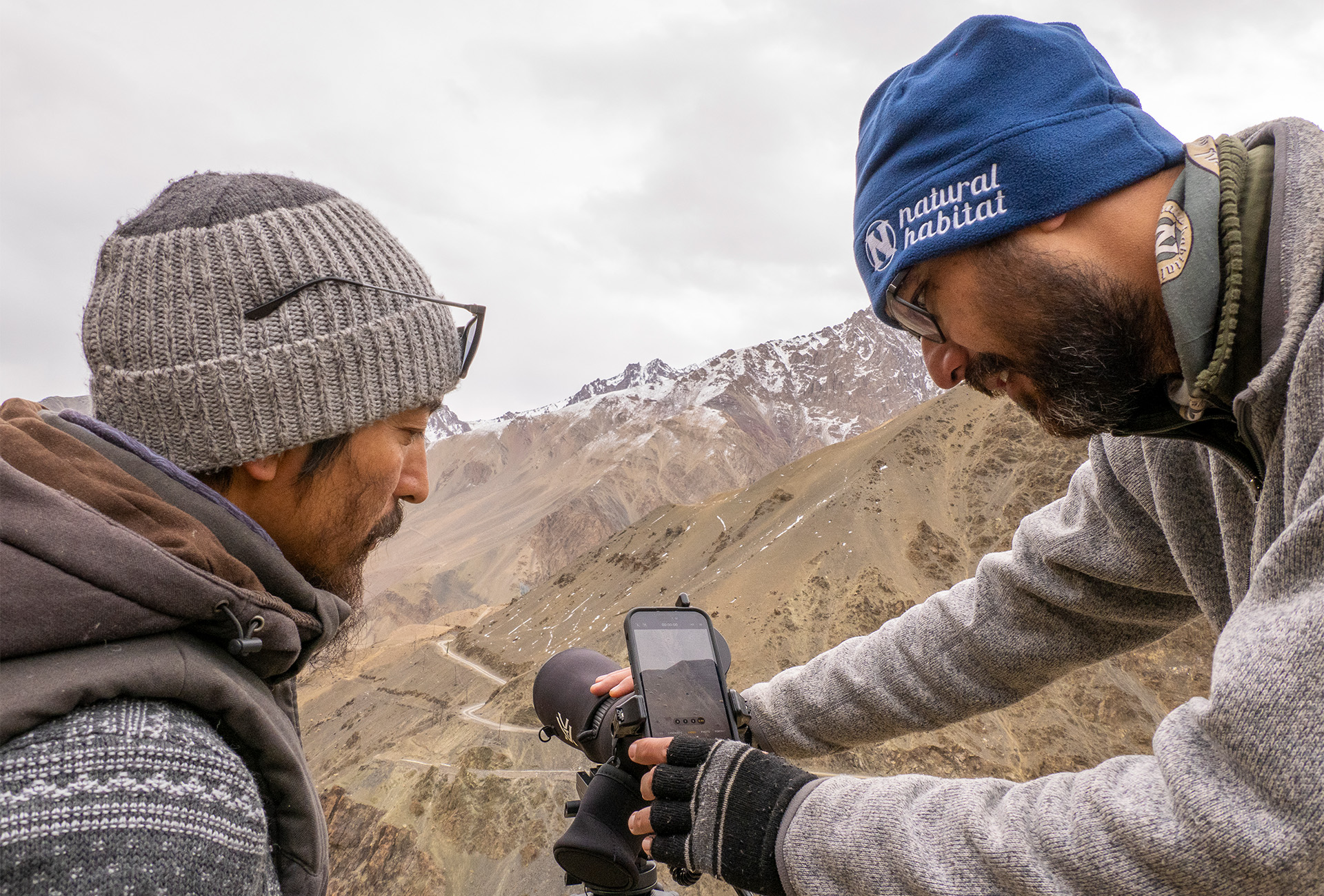 Conan Dumenil, Naturalist Guide and Spotter, helps traveler photograph, Grand Himalaya Range, Ladakh, India.